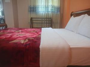 A bed or beds in a room at Snowdrop Resident