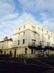 a large white building on the corner of a street at Two Top Central Unique Artisan Beach Studios - also separate spa cabin in Brighton & Hove