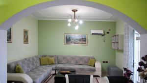 a living room with a couch and a table at Paris's Apartment in Gjirokastër