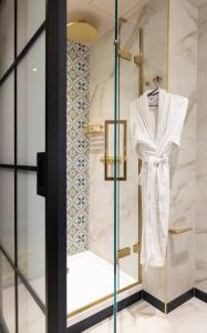 a dressing room with a white robe on a glass case at The Mercantile Hotel in Dublin