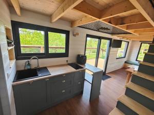 an interior view of a kitchen in a tiny house at Tiny House Le Petit Nid du Pré in Saint-Rémy