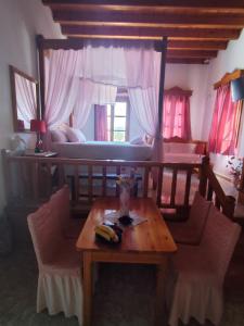 ein Wohnzimmer mit einem Tisch und einem Bett in der Unterkunft Studio sunrise in Kámpos + 11 Fotos