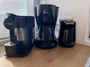 a black blender sitting on top of a wooden counter at Aquarius Luxury Suites in Ólimbos