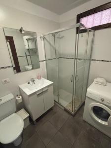 a bathroom with a shower and a toilet and a sink at Royal Apartment Los Cristianos in Los Cristianos +12 photos