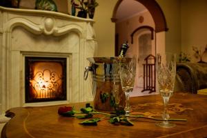 a table with two champagne glasses and a fireplace at Villa Wellness Budapest in Budapest