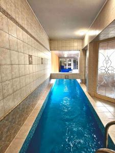 a pool in a hotel room with blue water at Villa Wellness Budapest in Budapest