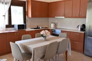 a kitchen with a table with a vase of flowers on it at Villa Asteria in Samothraki