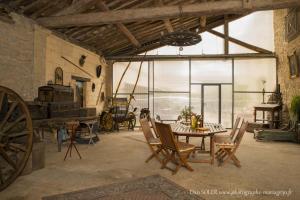 a room with a table and chairs in a building at Le Clos des Aramons in Bernis