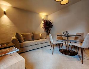 a living room with a couch and a table at Le Reve Charmant Apartments - Via De L ostan, 18 in Aosta