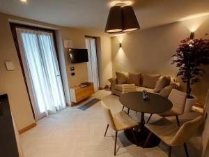 a living room with a couch and a table at Le Reve Charmant Apartments - Via De L ostan, 18 in Aosta