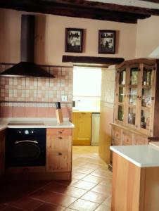 a kitchen with a black stove top oven in it at El Limonero in Arenas de Iguña +28 photos