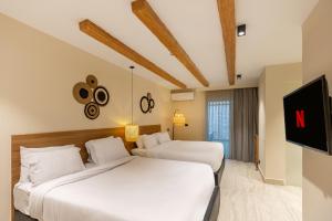 Postel nebo postele na pokoji v ubytování La Boutique Hôtel - Vue Des Pyramides
