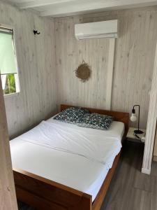 a bedroom with a bed in a room with a window at LaKaz Daniel - Bungalow avec piscine in Saint-Pierre