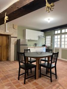 a kitchen with a table and chairs in a room at La Maison Tanneur, centre ville historique à 5mn de Beauval in Saint-Aignan