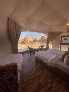 a bedroom with two beds and a view of the ocean at Rum Magic Desert in Wadi Rum