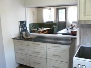 a kitchen with a counter top and a living room at Hillside - Adventure Norway in Bjelland