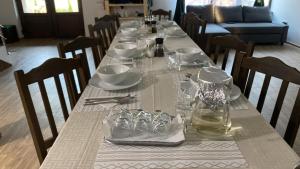a long table with chairs and plates and glasses on it at La Luca in Maliuc