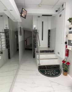 a hallway with stairs and a rug in a building at Little Palace in Cannes