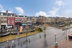 a city with a river and buildings and a street at Authentic sleeping in the city center in Leeuwarden