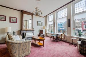 a living room filled with furniture and a fireplace at Authentic sleeping in the city center in Leeuwarden