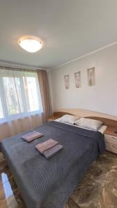 a bedroom with a large bed with two towels on it at База відпочинку «Павлоградець» in Orlovshchina
