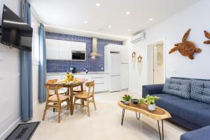 a living room with a blue couch and a table at La Tortuga Azul A in Puerto de la Cruz