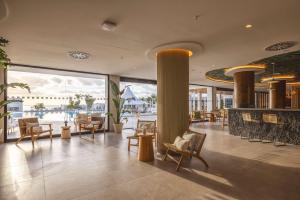 a lobby of a hotel with chairs and tables at Radisson Blu Resort, Lanzarote Adults Only in Costa Teguise