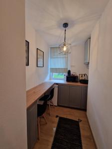 a kitchen with a wooden counter and a table at La Tanti Coman in Şugag