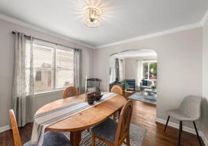 a dining room with a wooden table and chairs at Cozy 3-Bedroom Near Cleveland in Euclid