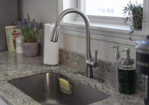 a kitchen counter with a sink and a window at Cozy 3-Bedroom Near Cleveland in Euclid +53 photos