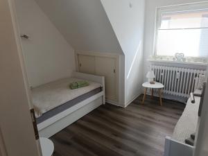 a small bedroom with a bed and a window at Ferienwohnung Harz Valley -Mit Fernblick in den Harz. in Goslar +41 photos