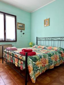 a bedroom with a bed with a colorful comforter at Casa Rosa in Toscolano Maderno