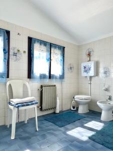 a bathroom with a toilet a sink and a radiator at Casa Rosa in Toscolano Maderno +46 photos