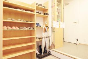 a walk in closet with wooden shelves at 花乃郷 池袋f in Tokyo