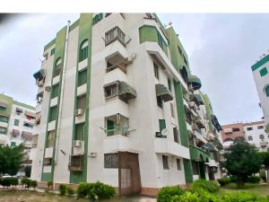 an apartment building with green and white at Gadou Rooms -Private & Shared Stays in Port Said Best Location in Port Said
