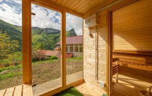 a view from the outside of a wooden house with a large window at Retraites & Séminaires, Spa, La Ressource Malix 15 personnes in Tenay +21 photos
