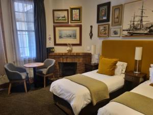 Ένα ή περισσότερα κρεβάτια σε δωμάτιο στο Ashanti Gardens Guesthouse
