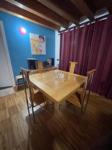 a dining room with a wooden table and chairs at 62 B&B in Vicenza