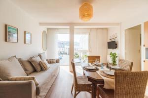 a living room with a couch and a table at Magnifique appartement plage de Trestraou in Perros-Guirec