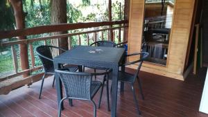 a table and chairs on the porch of a cabin at Bogi vendégház in Mezőkövesd