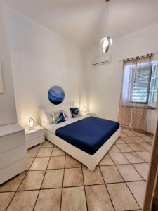 a bedroom with a large bed with a blue blanket at Gente di Mare in Maratea