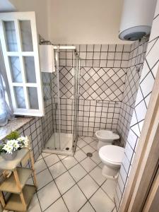 a bathroom with a shower and a toilet at Gente di Mare in Maratea +8 photos