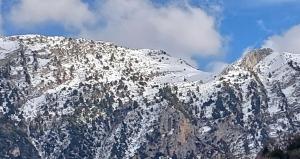 a mountain covered in snow with a cloudy at Sergios Rooms votonosi metsovo!!! in Votonósion