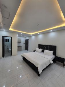 a large bedroom with a large bed and a ceiling at Crystal Heights in Lahore