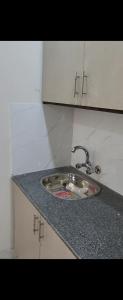 a kitchen counter with a sink in a kitchen at Crystal Heights in Lahore