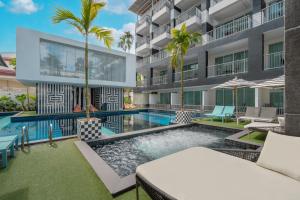 an exterior view of a building with a swimming pool at Sugar Marina Hotel - FASHION - Kata Beach in Kata Beach