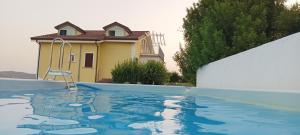 a swimming pool in front of a house at Villa Lancellotti in Agropoli