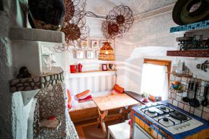 a small kitchen with a stove and a table at Apartment Sonca in Bled