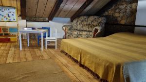 a bedroom with a bed and a chair and a table at Charming stone villa in a peaceful setting near Crikvenica in Barci