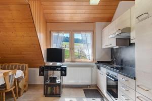 a kitchen with a table with a tv on it at Ferienwohnung Armbruster in Sankt Georgen im Schwarzwald
